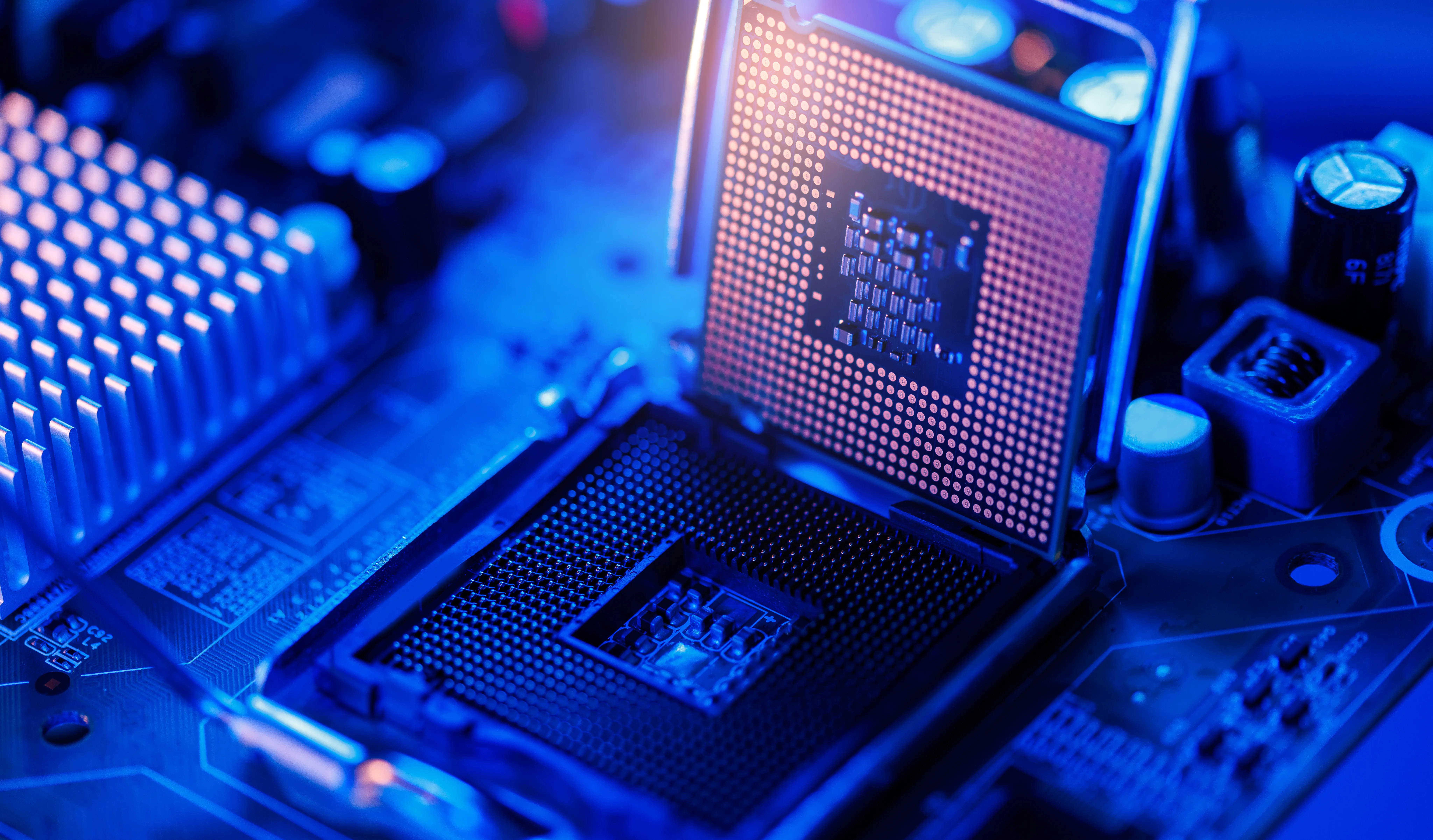Computer cpu chip being installed on motherboard closeup with neon blue lighting for technology data center AI